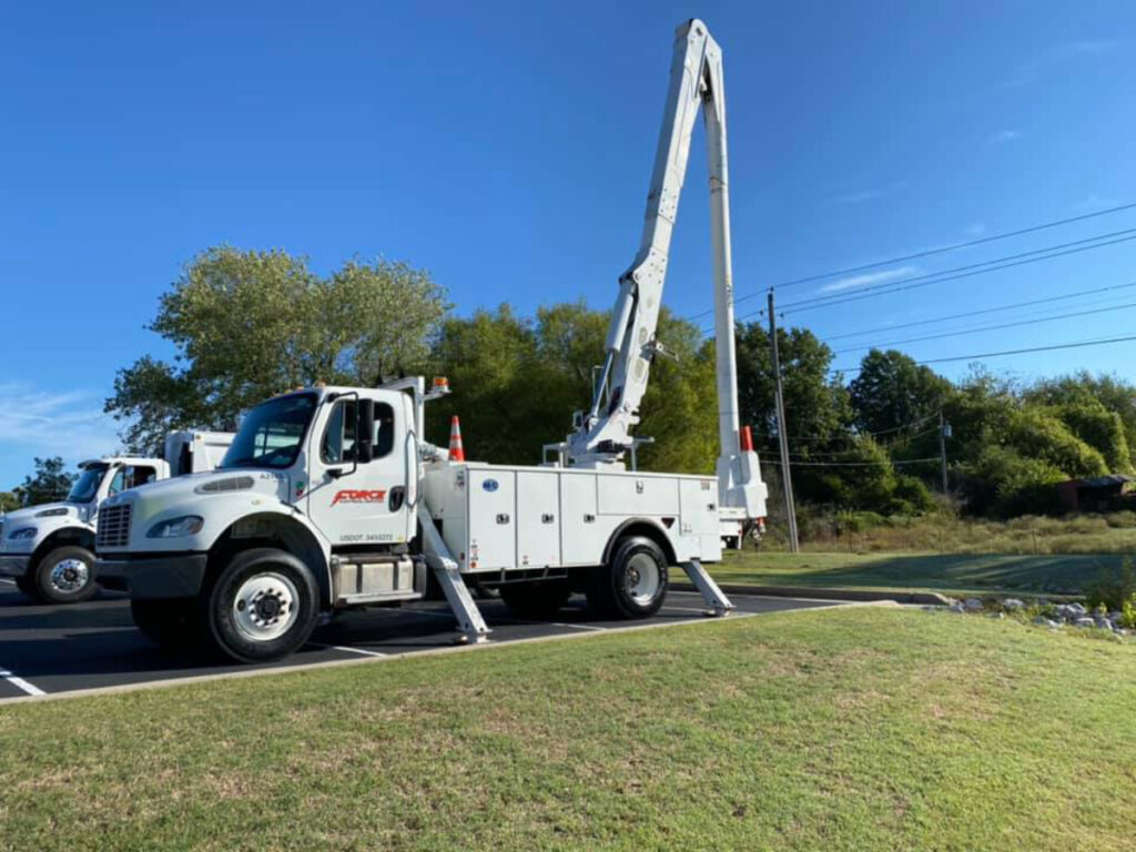 Force Electric bucket trucks staged for distribution work