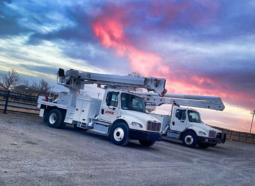 Force Electric line trucks at the end of a work day
