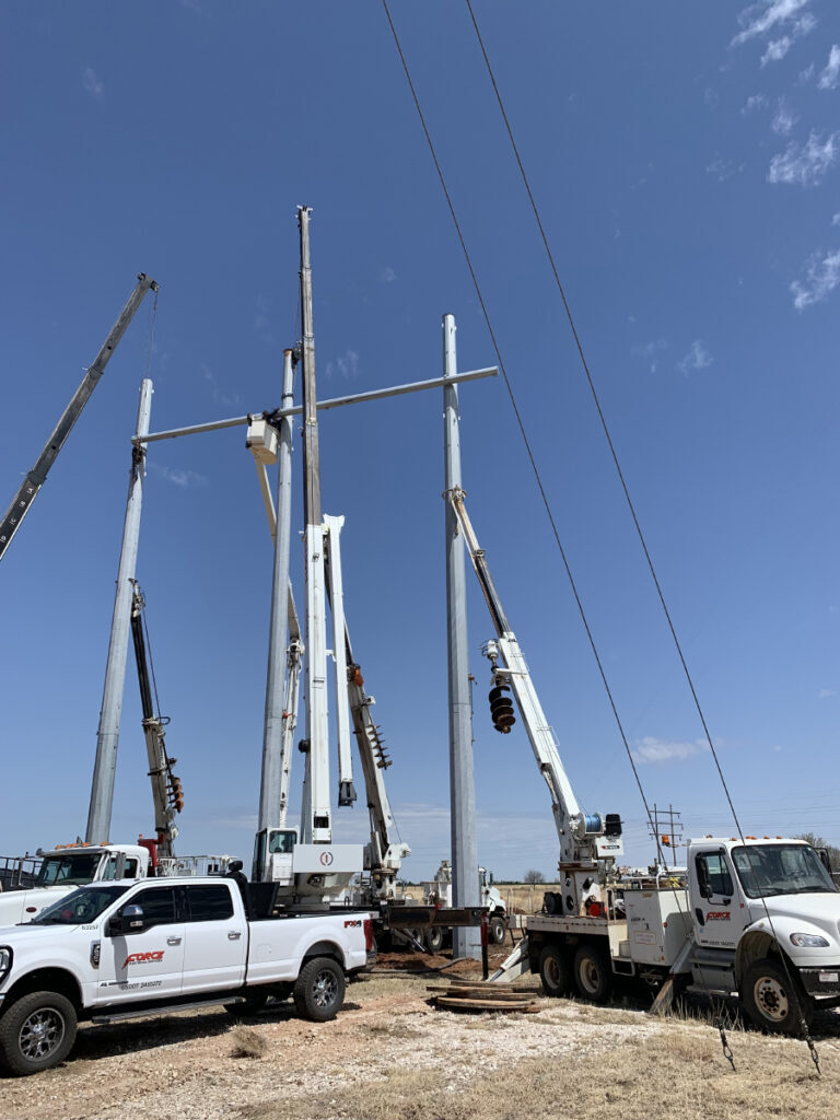 Force Electric crew setting transmission poles